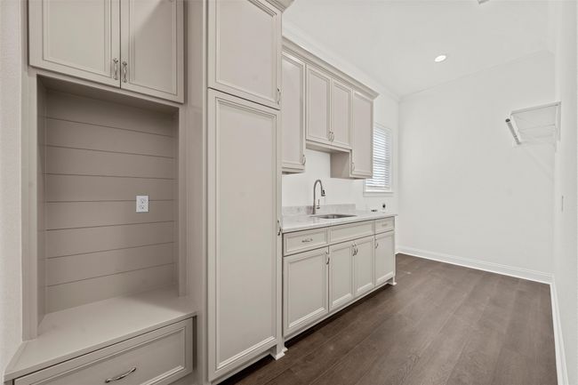Kitchen featuring dark wood finished floors and light countertops | Image 28