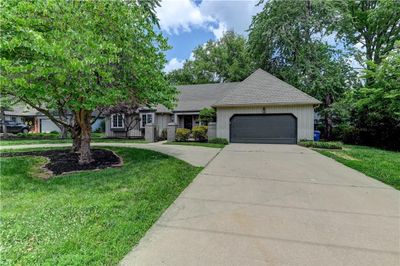 View of front of home with a garage and a front lawn | Image 1