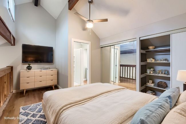 Bedroom featuring beamed ceiling, ensuite bathroom, light wood-style floors, high vaulted ceiling, and a ceiling fan | Image 15