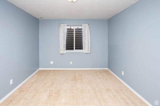 Carpeted spare room featuring baseboards | Image 25