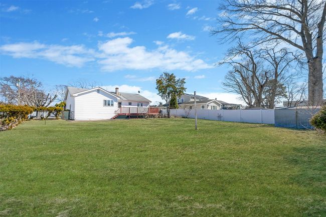 View of yard with a fenced backyard and a wooden deck | Image 5