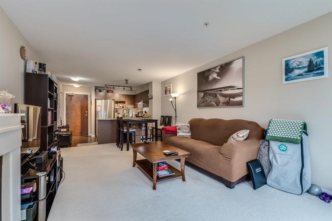 Living area with track lighting and carpet floors | Image 12