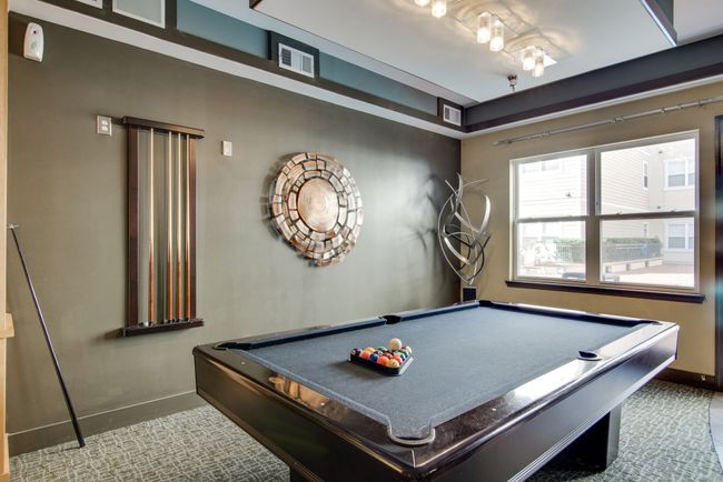 Enjoy the resident game room featuring a pool table, modern lighting, large windows, and bold accent walls—perfect for relaxing or entertaining. | Image 27