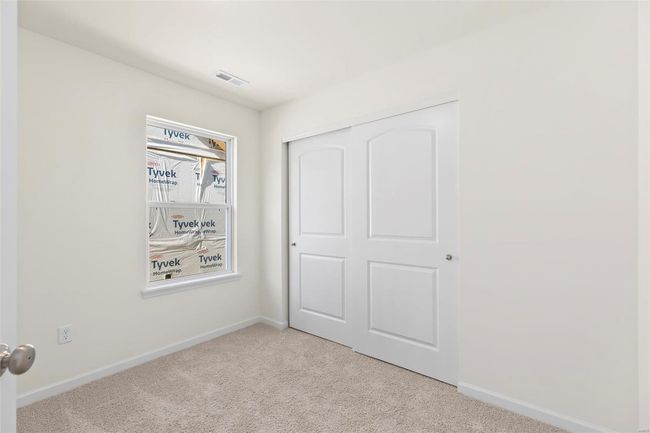 Unfurnished bedroom featuring a closet and light colored carpet | Image 24