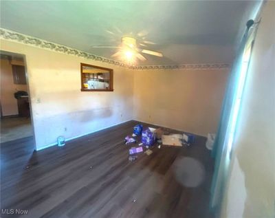 Empty room with ceiling fan and dark hardwood / wood-style floors | Image 2