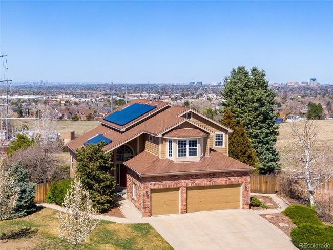 Traditional-style house featuring a garage, brick siding, driveway, and fence | Image 29