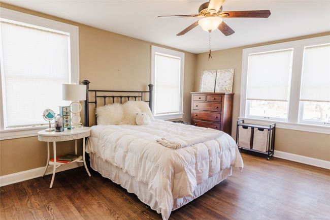 Bedroom featuring ceiling fan and dark hardwood / wood-style flooring | Image 31