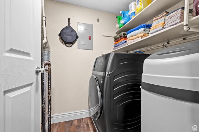 Laundry area featuring electric panel and dark wood-style floors | Image 12