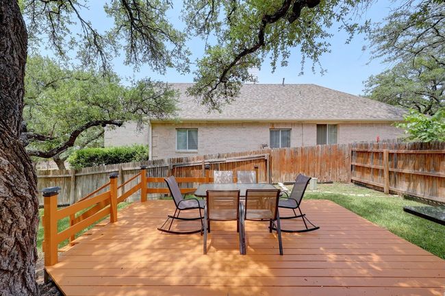 Wooden terrace featuring a fenced backyard and outdoor dining space | Image 33