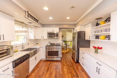 Fresh new bright kitchen, quartz counters, stainless steel appliances, hardwood floors, ceramic backsplash custom stainless sink and more | Image 3