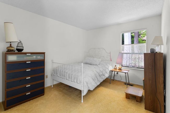 Carpeted bedroom featuring a textured ceiling | Image 22