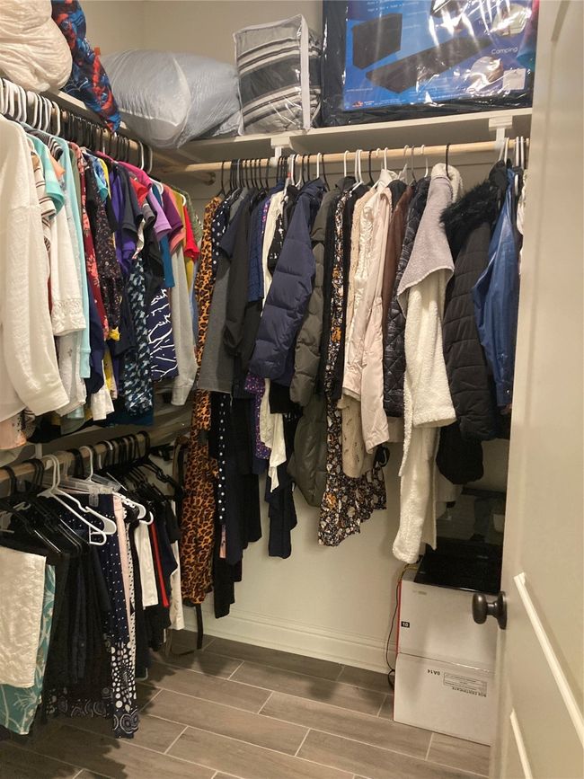 Walk in closet with wood finished floors | Image 16