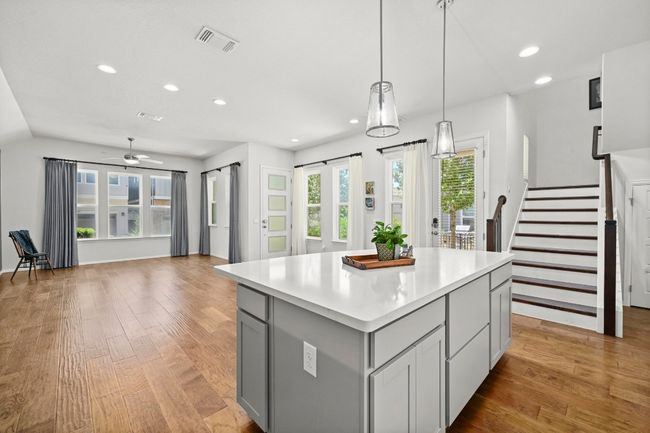Kitchen featuring gray cabinetry, recessed lighting, light countertops, light wood-style flooring, and a center island | Image 12
