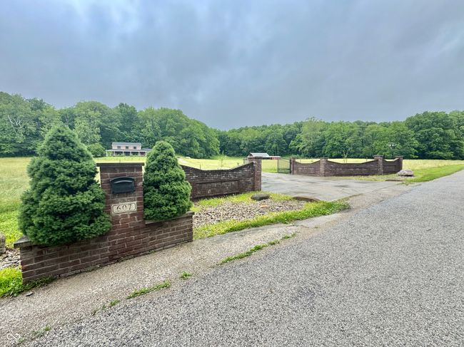 community sign with a wooded view | Image 15
