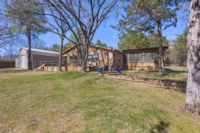 View of yard with an outbuilding and fence | Image 15