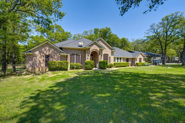 View of front of home with brick siding and a front lawn | Image 4