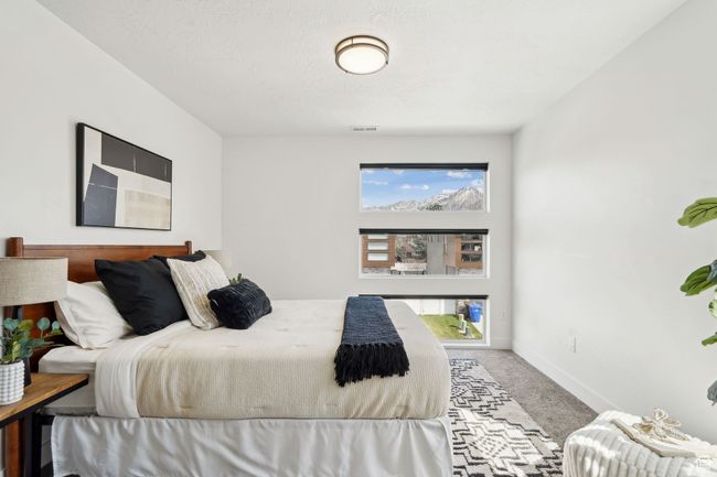 Bedroom featuring visible vents, baseboards, and carpet flooring | Image 27