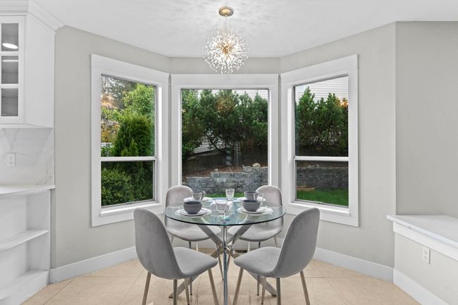 Dining room featuring baseboards, an inviting chandelier, and light tile patterned flooring | Image 14