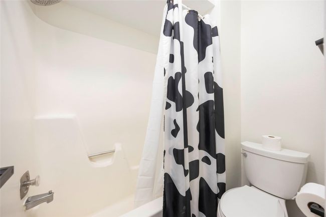 The second-floor primary bathroom includes a combined bathtub and shower, along with a toilet, offering full functionality. | Image 18