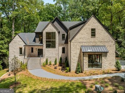 Front of Structure - Welcome to 119 Le Brun Road! A stately all-brick and stone structure sitting on a private lot back off the neighborhood street. | Image 1