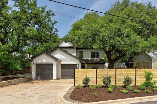 View of front of property with driveway, fence, and an attached garage | Image 27
