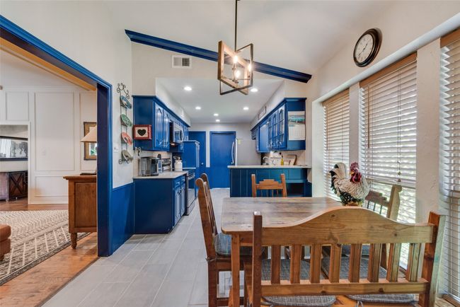 Dining space with lofted ceiling | Image 19