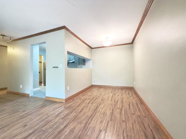 Unfurnished room with ornamental molding, wood finished floors, and baseboards | Image 7