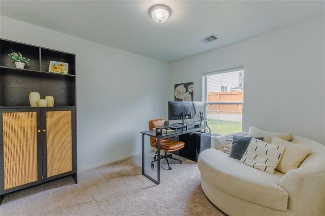 Bedroom or Office on the First Floor! This could be used as a multi generational bedroom for extended family as well. The window has a view of the fully privacy fenced backyard. | Image 13