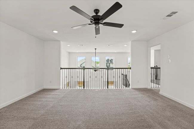 Carpeted empty room featuring a ceiling fan and recessed lighting | Image 32