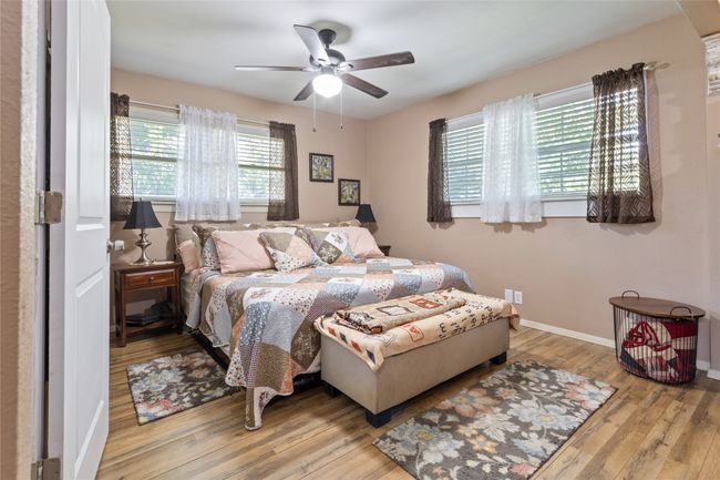 Bedroom featuring light wood finished floors and a barn door | Image 9