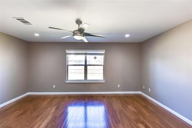 Spare room with wood finished floors, a ceiling fan, and recessed lighting | Image 21