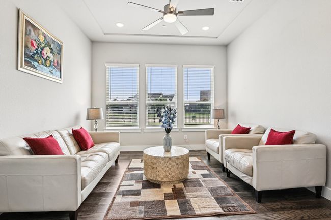 Living area with ceiling fan, dark wood finished floors, and recessed lighting | Image 7