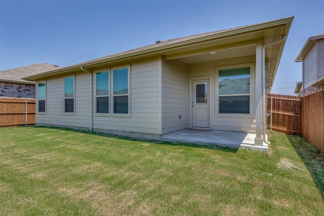 Rear view of house with a patio area and a lawn | Image 23