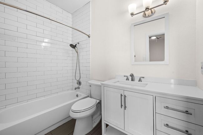 Bathroom featuring vanity, toilet, and shower / tub combination | Image 11