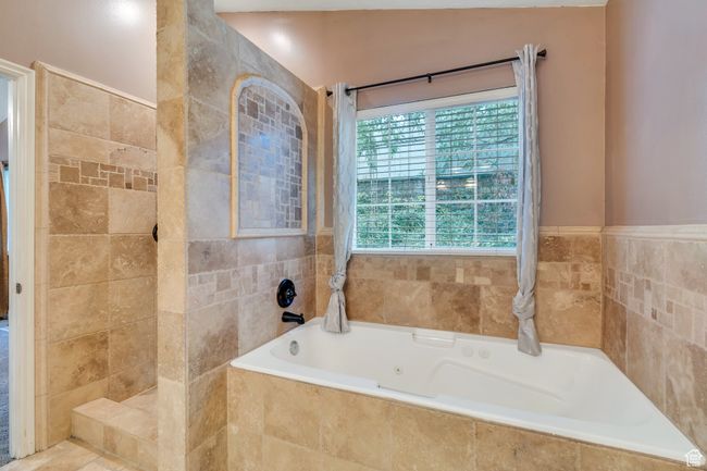 Bathroom with tile walls and a garden tub | Image 11