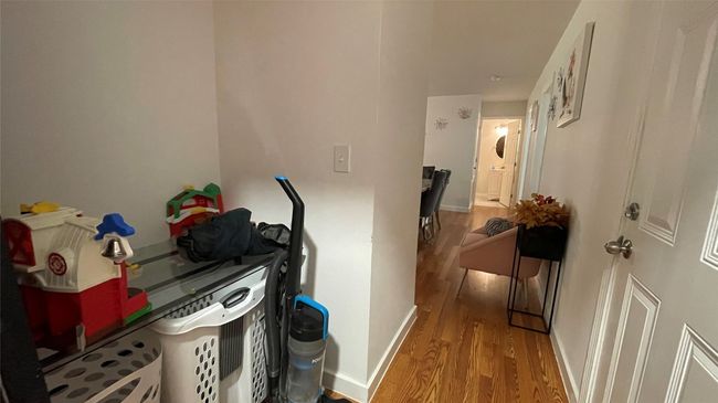 Hall with wood finished floors and baseboards | Image 7