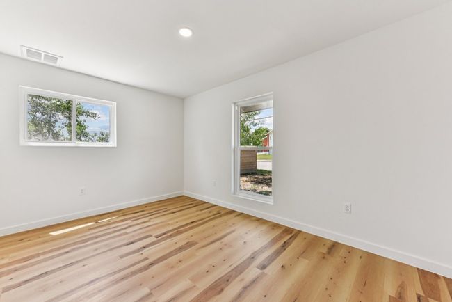 Spare room featuring wood finished floors and recessed lighting | Image 21
