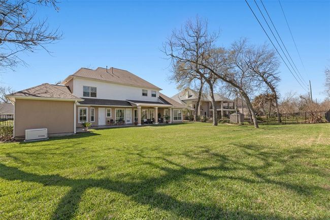 Enjoy the 1/2 acres of a been of wide open space and mature trees. Covered patio and a touch of country living still close to the city. | Image 45