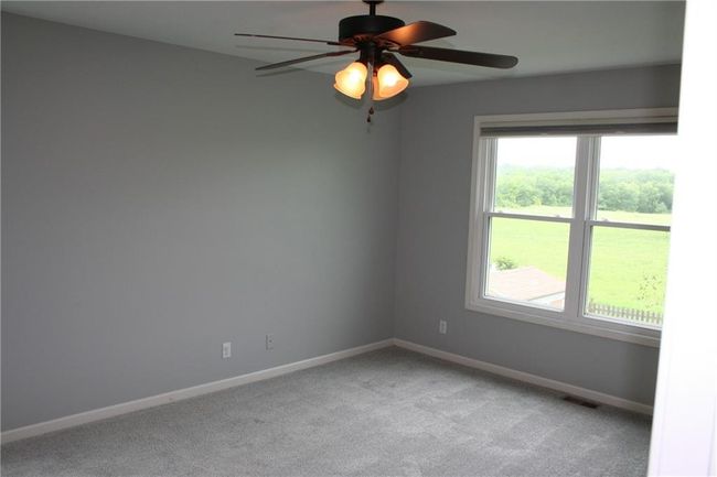 Unfurnished room with light carpet and a ceiling fan | Image 9