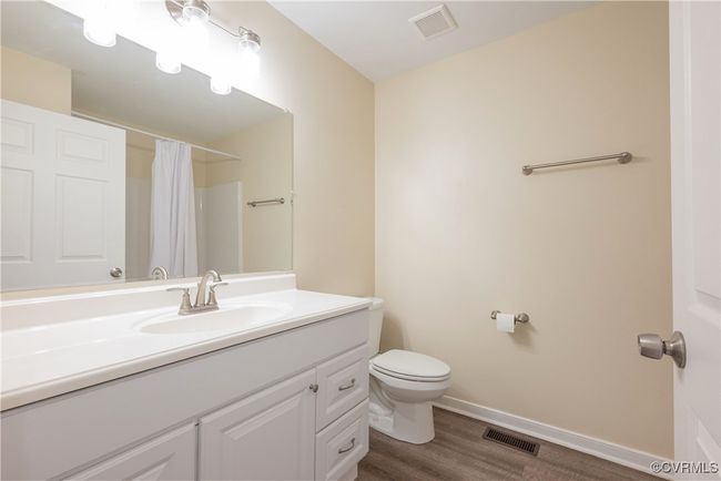 Bathroom featuring visible vents, wood finished floors, toilet, and vanity | Image 22