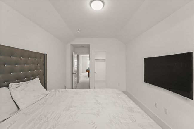 Bedroom featuring lofted ceiling | Image 19