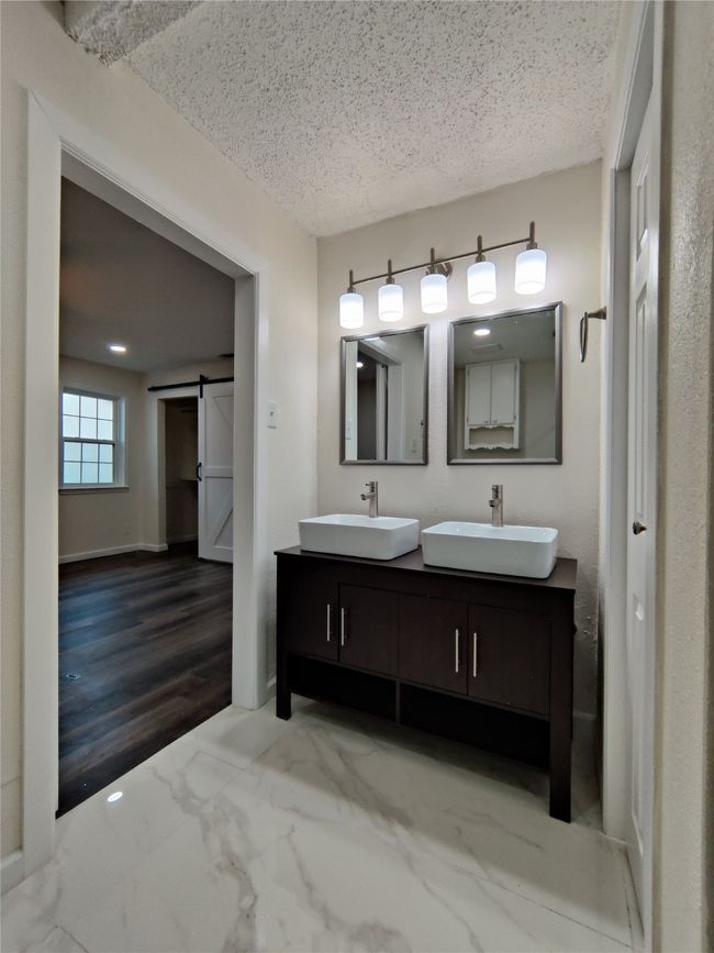 Bathroom with hardwood / wood-style flooring, a textured ceiling, and vanity | Image 15