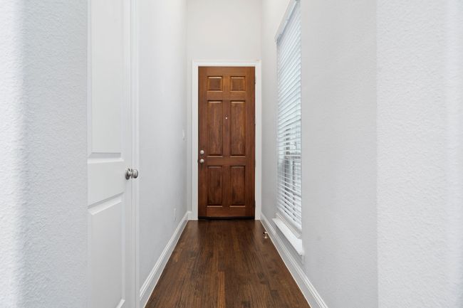 Entryway with dark wood finished floors and a textured wall | Image 4