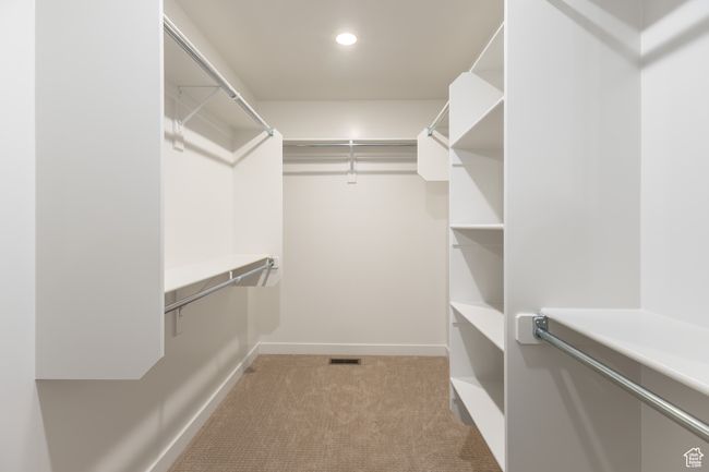 Spacious closet featuring light colored carpet | Image 21