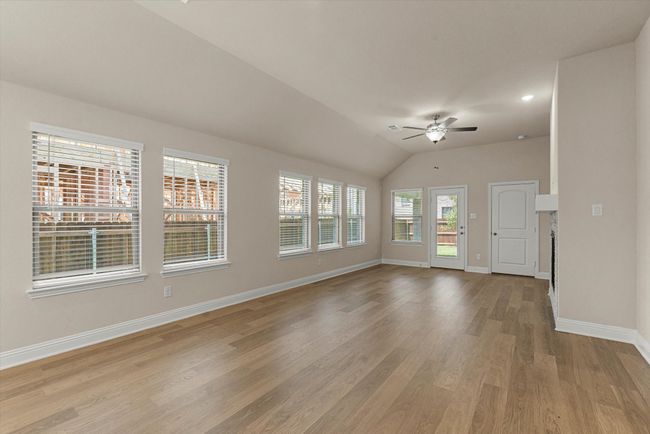 Living room with ceiling fan, baseboards, light wood-style flooring, lofted ceiling, and recessed lighting. | Image 8