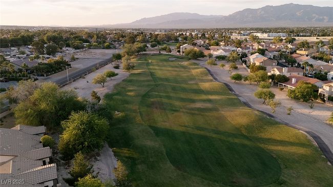 View of property location featuring nearby suburban area, mountains, and a local golf course | Image 4