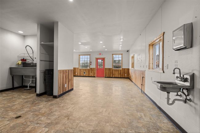 Hallway with a sink, recessed lighting, stone finish floors, and a wainscoted wall | Image 61