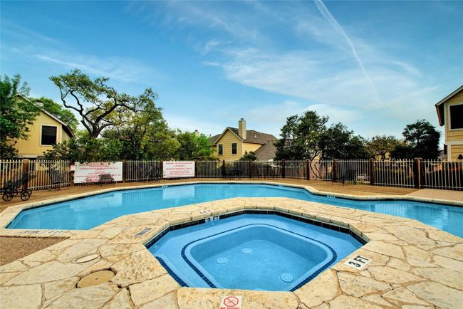 Pool with a hot tub and fence | Image 22