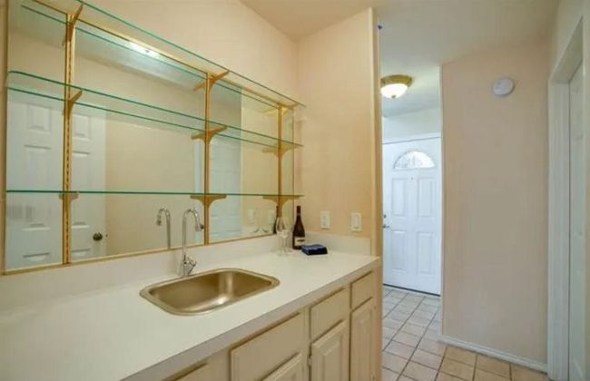 Bathroom with tile patterned floors, vanity, and baseboards | Image 4