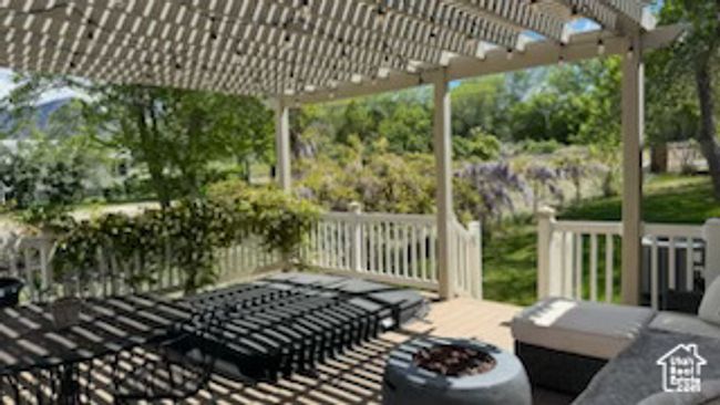 View of patio with a pergola and a fire pit | Image 35
